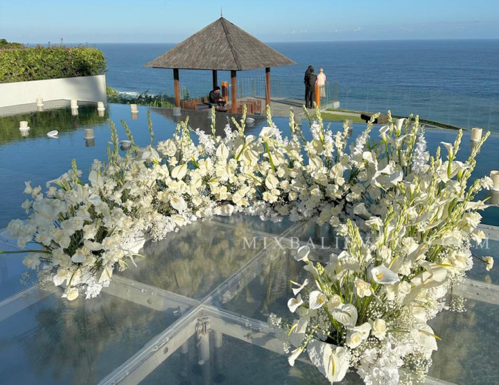 Stylish Infinity Pool Ocean Wedding with guests at a luxurious Villa above the Indian Ocean in Bali